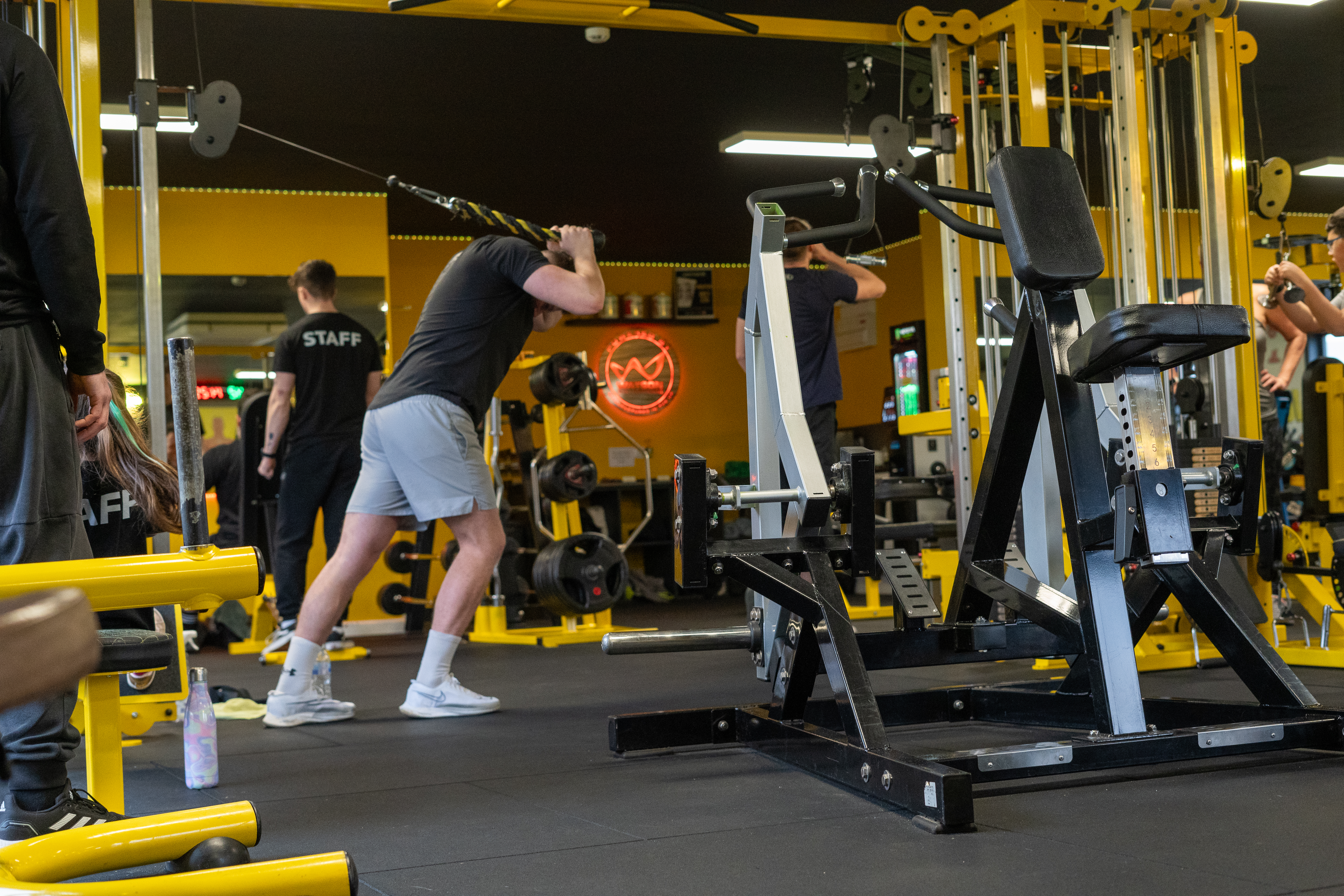Fitness class participants exercising together in a gym studio